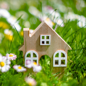 spring real estate market represented by a house with spring flowers